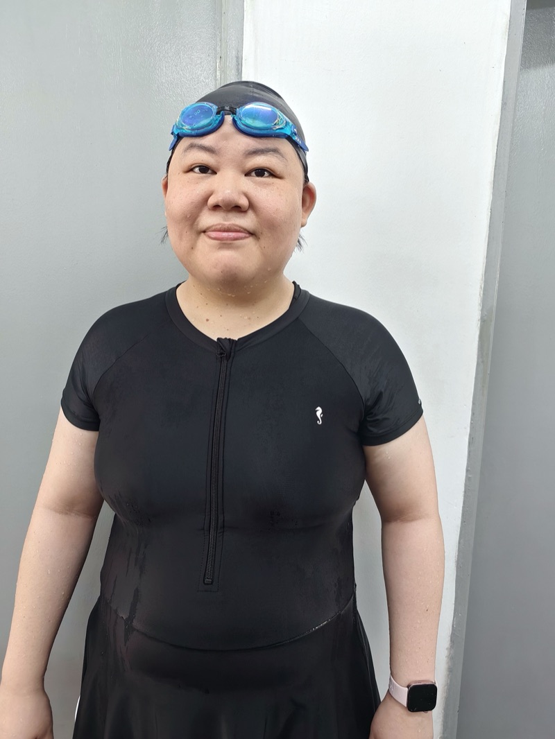 Coach Sheryie, kids and water safety coach, poolside in her swim cap and goggles