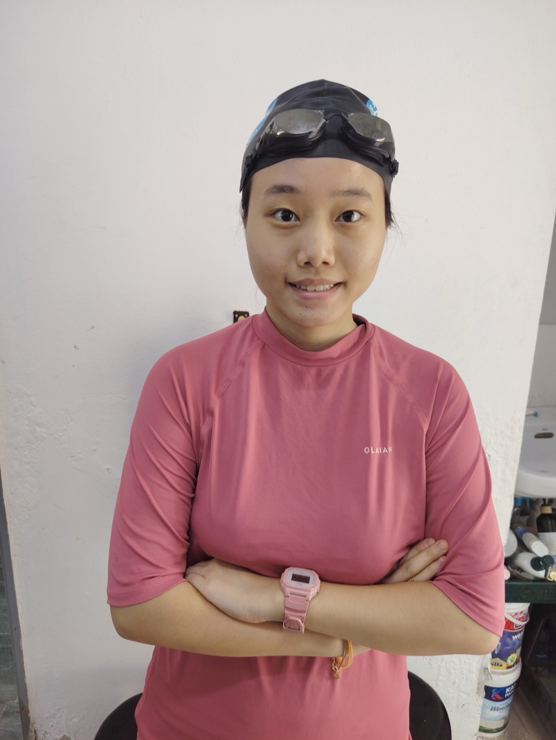 Coach Yiqi, baby and toddler coach, poolside in her swim cap and goggles