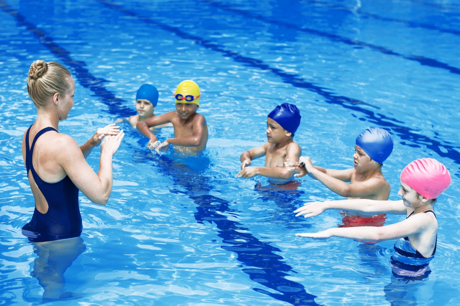 JC Swimming coach teaching a group class