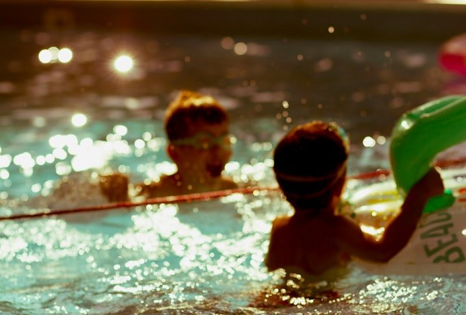 Siblings swimming together